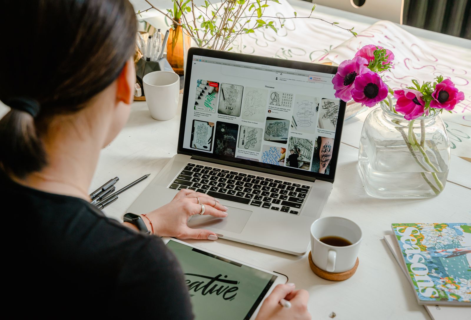 Designer working at a desk with a large monitor