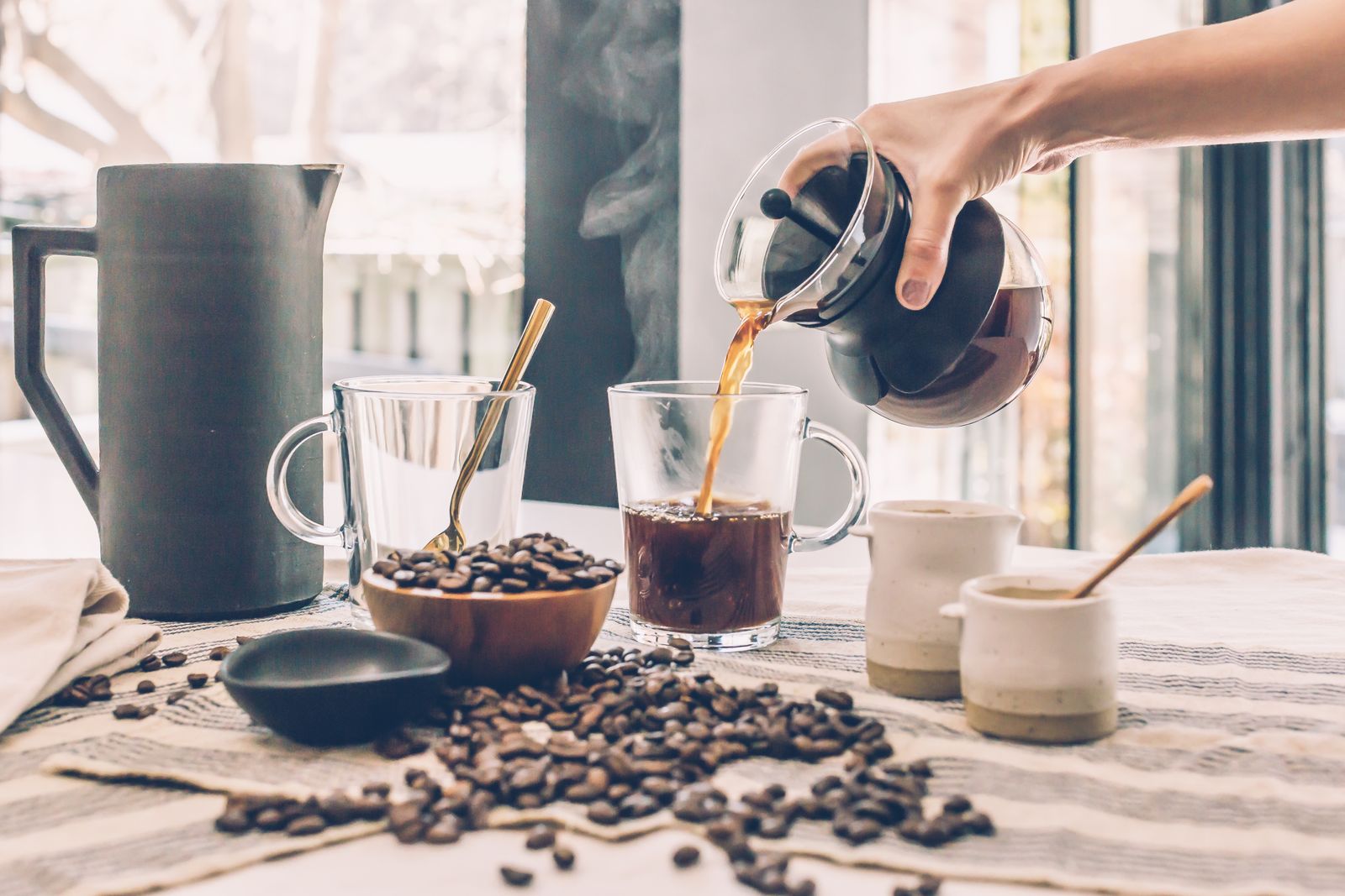 Person preparing pour-over coffee with a paper filter