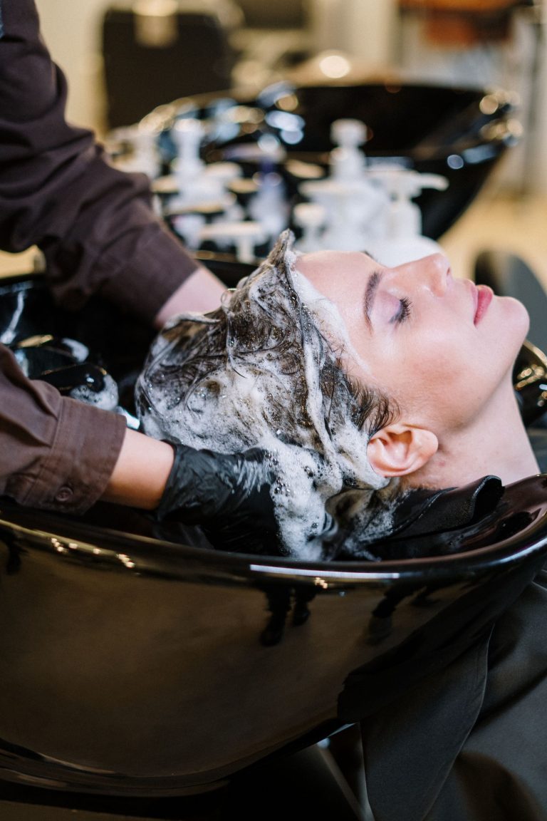 Woman styling her hair while looking in a mirror