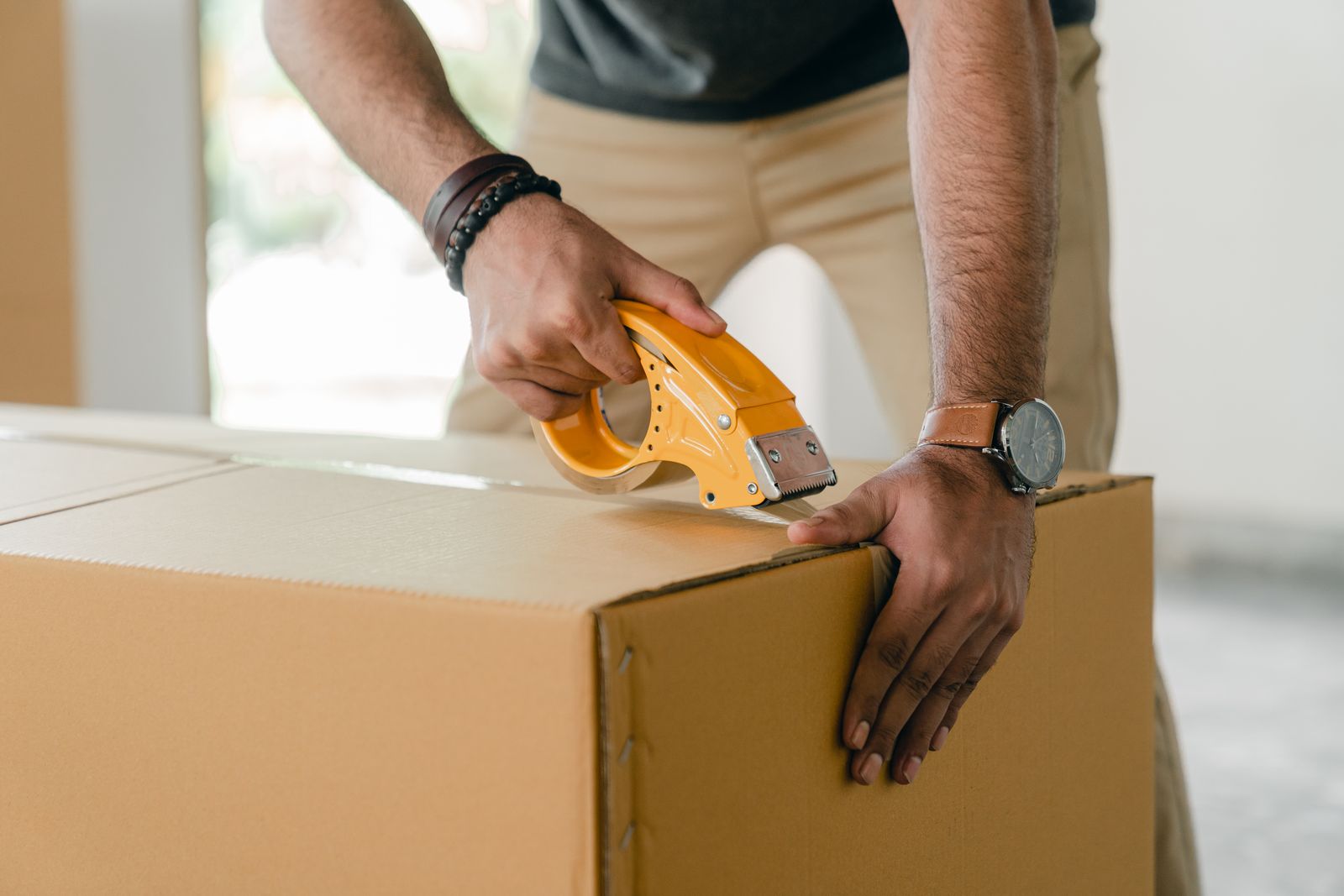 A shopper holding a cardboard parcel for return